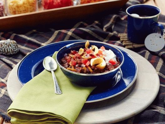 Foto del Cile di manzo con fagioli e condimento a scelta