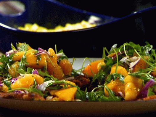 Foto di un impanato di formaggio tritato di pollo con rucola e arance