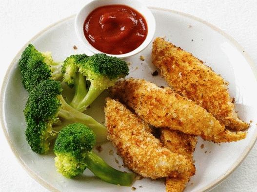 Foto di bastoncini di pollo con contorno di broccoli al vapore