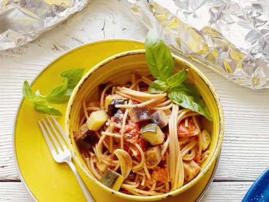 Spaghetti sani con verdure estive in un foglio grigliato